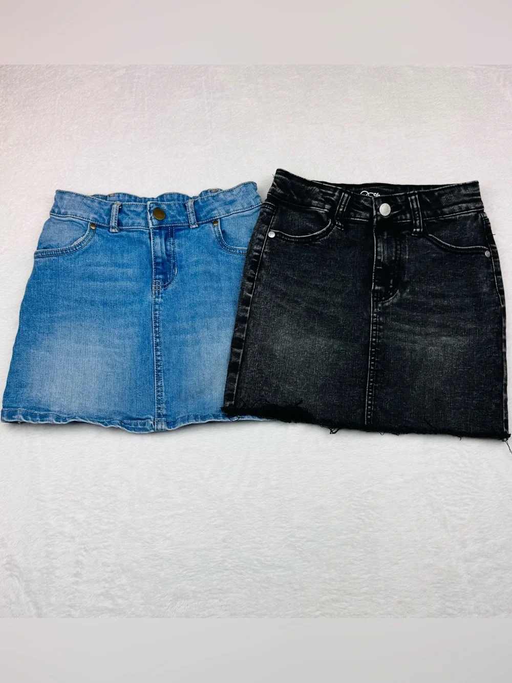 Lot of 2 girls denim skirts. The blue shirt is a size 8, black skirt is size 7/8